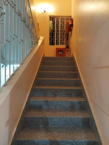 a stairway leading up to the second floor of a house at Hotel Hari Gayatri Regent in Guwahati