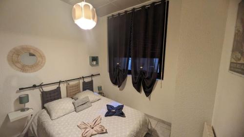 a bedroom with a bed with blue bows on it at Pieds dans l'eau - Lac Léman - 2 min Evian - Spacieux in Neuvecelle