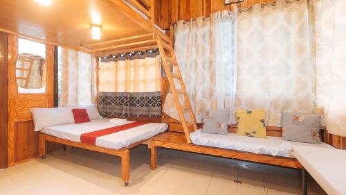 a room with two bunk beds and a ladder at RedDoorz @ Cristina's Hideaway Resort Tanay in Rizal