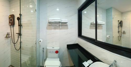 a bathroom with a sink and a toilet and a mirror at Mountain&Sea Hotel Prachuap in Prachuap Khiri Khan