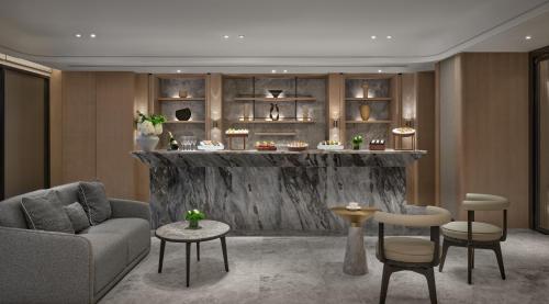 a living room with a couch and a bar at InterContinental Shenzhen WECC by IHG in Shenzhen