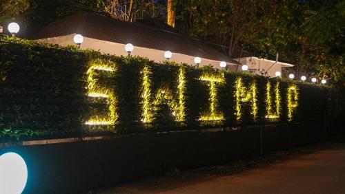 a hedge with a sign that says endflation at Swimup - Suites with private pool , Vagator in Vagator