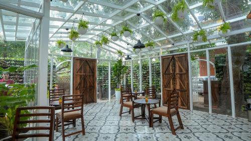 a conservatory with a table and chairs in it at Swimup - Suites with private pool , Vagator in Vagator