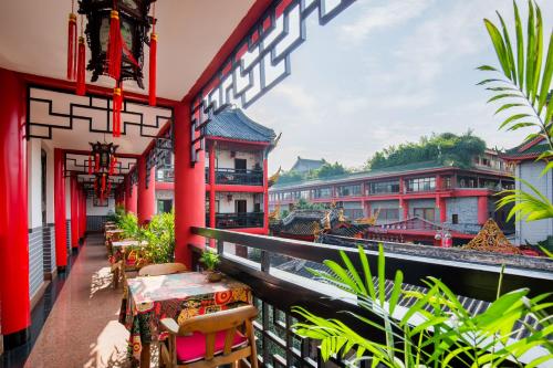 a balcony of a building with a table and chairs at Wenjun Courtyard Hotel Chengdu ( Kuanzhai Branch) in Chengdu