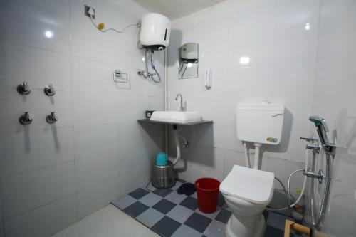 a bathroom with a toilet and a sink at Signature Inn Orchha in Orchha