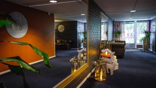 a living room with a couch and a mirror at Hotel Golden Circle Suites in Rovaniemi