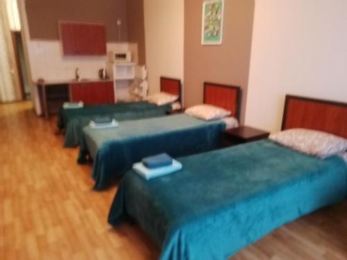 a group of four beds in a room at SunLake Hotel Osokorki in Kyiv