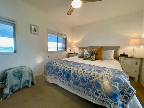 a bedroom with a large bed and a window at The Vigneron's Cottage at Dragonfly Estate Vineyard - Stanthorpe in Severnlea