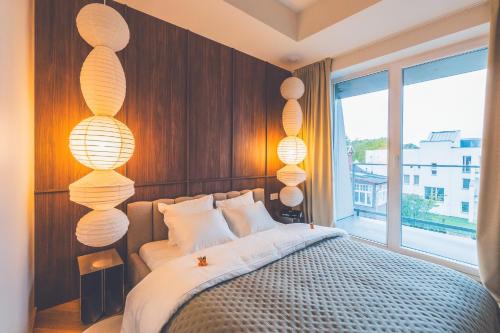 a bedroom with a bed with lights on the wall at Second Home Stay 17 in Pärnu