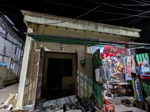 a small building with a door in a street at Padmini Nivas in Brahmapur