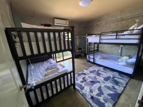 two sets of bunk beds in a room at Sea Skyline family in Sattahip
