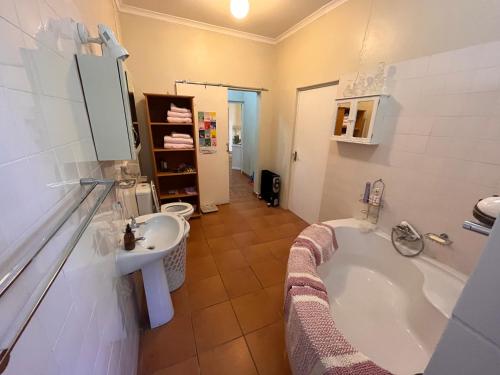 a bathroom with a bath tub and a sink at Haze Inn Cottage in Rosetta