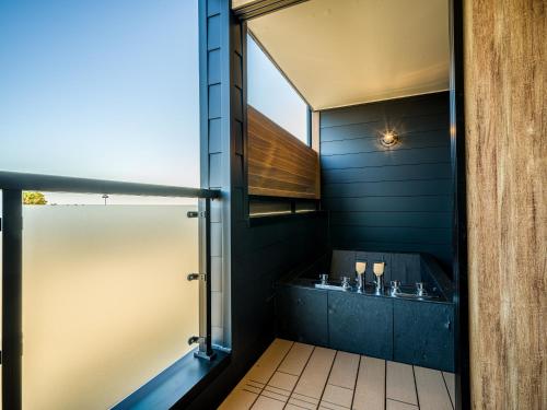 a bathroom with a shower and a sink at Rakuten STAY MOTEL Kujukurihama Katakai in Kujukuri