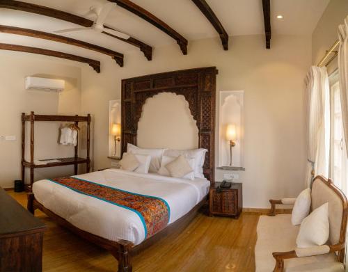 a bedroom with a large bed in a room at Khamma Ghani A Boutique Hotel in Udaipur