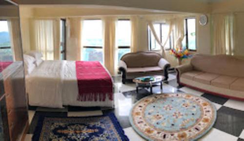 a living room with a couch and a table at Aizawl Guest House, Aizwal in Āīzawl