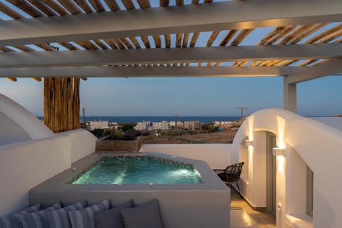 a swimming pool on the roof of a house at Aegean Diamonds Luxury Suites in Monolithos