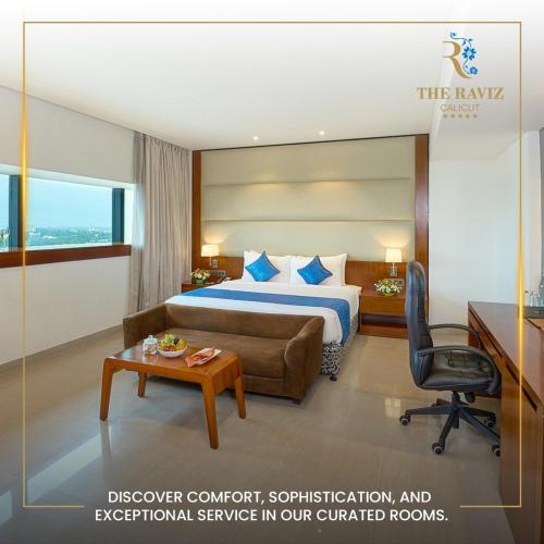 a hotel room with a bed and a desk at The Raviz Calicut in Kozhikode