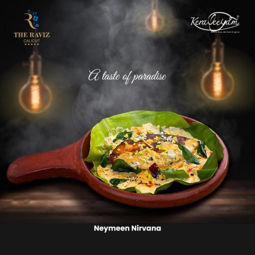 a plate of food in a wooden spoon at The Raviz Calicut in Kozhikode