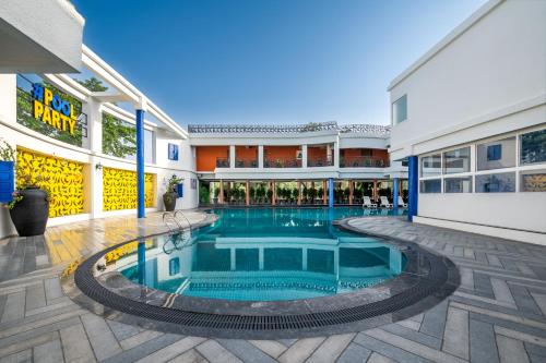 a swimming pool in the middle of a building at Roadies Rostel - Best Adventure Resort in Ahmedabad in Kanīj