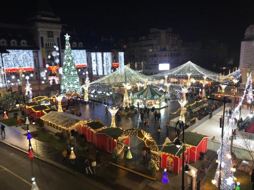 a christmas market in a city with christmas lights at Blue light ultracentral in Craiova