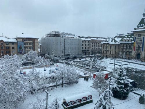 a city covered in snow with a bus at Blue light ultracentral in Craiova