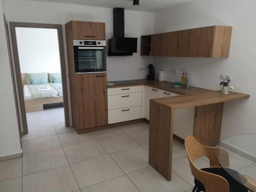 a kitchen with wooden cabinets and a counter top at Apartments Ole in Tolmin