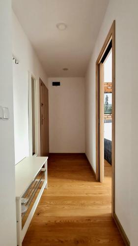 an empty room with a table and an open door at Apartamenty Dębowa 3 in Polanica-Zdrój