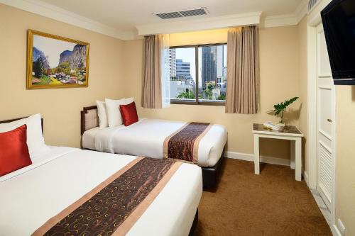 Säng eller sängar i ett rum på Court Wing Hotel Sukhumvit Bangkok