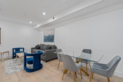a living room with a glass table and chairs at Capitol View1 Charming Oasis in DC near Metro with Fenced Backyard Free Parking and WIFI in Washington, D.C.