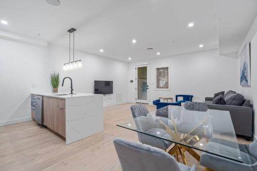 a kitchen and living room with a glass table at Capitol View1 Charming Oasis in DC near Metro with Fenced Backyard Free Parking and WIFI in Washington, D.C.