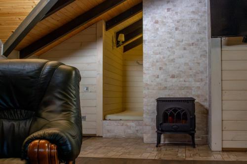a leather chair in a living room with a stove at BRB Park Hotel in Vizhenka