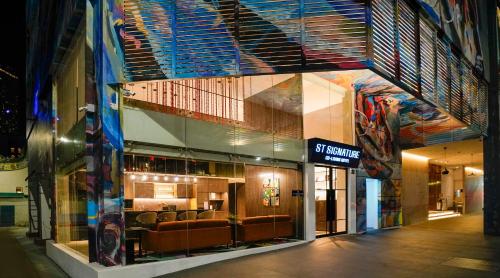 a building with a store with chairs in it at ST Signature Bugis Middle in Singapore