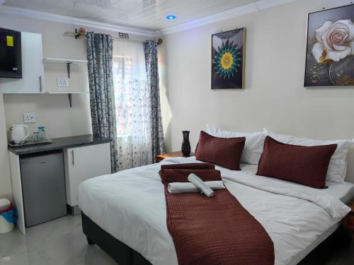 a bedroom with a bed with a towel on it at Essential Lodge23 in Cape Town