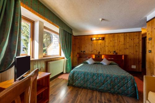 Postel nebo postele na pokoji v ubytování Hotel Bouton D'Or - Cogne