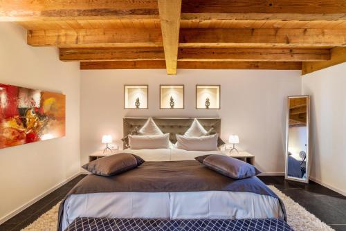 a bedroom with a large bed with two tables at Rebenhaus Loft in Baden-Baden