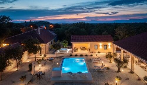 an aerial view of a house with a swimming pool at Tosic Estate - Villa, Vineyards and Winery in Razvođe
