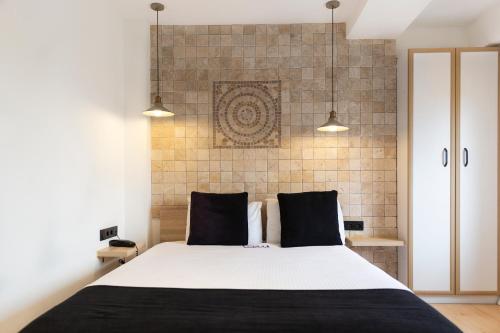 a bedroom with a large white bed with two pillows at Ada Apart Otel in Izmir