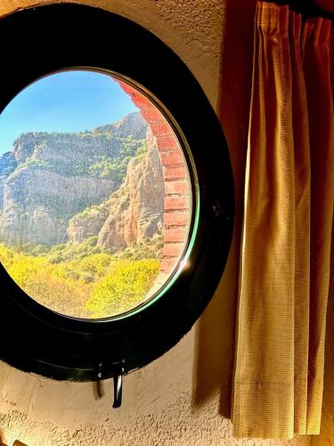 a window with a view of a mountain view at Muntenia Inn Apartments and Suites in Kalavrita