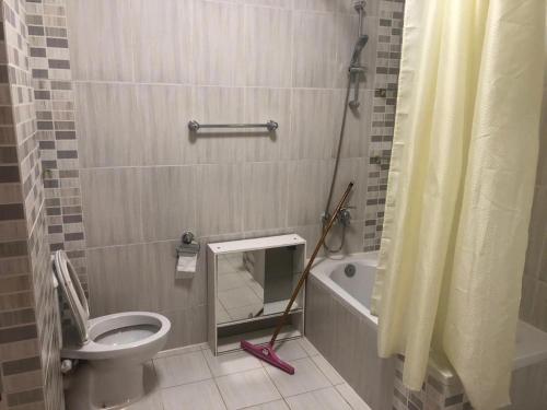 a bathroom with a toilet and a sink and a shower at Moubark 6 Studio in Hurghada