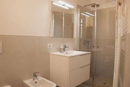 a white bathroom with a sink and a shower at Arco Downtown Castleview in Arco