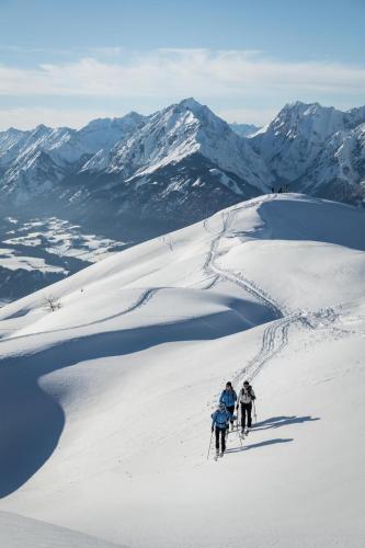 two people skiing down a snow covered mountain at Ferienwohnung Gipfelblick in Weerberg