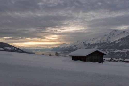 a snow covered hut on top of a snow covered mountain at Ferienwohnung Gipfelblick in Weerberg