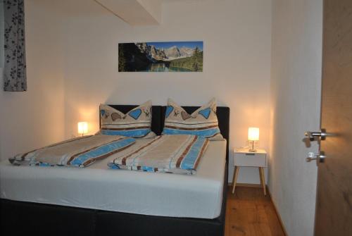 a bedroom with a bed with two pillows at Ferienwohnung Gipfelblick in Weerberg