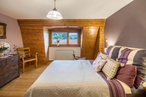 um quarto com uma cama e uma parede de madeira em Vogelsberger Cosy Home-ganzes Haus 