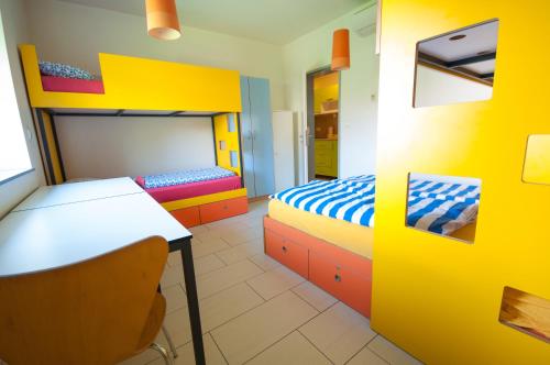 a room with two beds and a table and a desk at Simbol Rooms with free private parking in Ljubljana