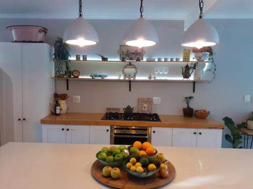 a kitchen with a bowl of fruit on a counter at 1 Croft Cottage, in Knysna