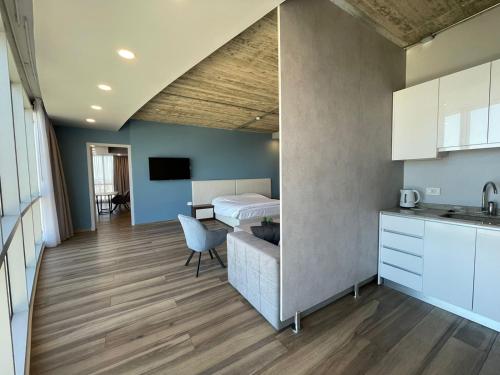 a kitchen and a bedroom with a bed and a table at The Stay Furnished Apartments in Dbayeh