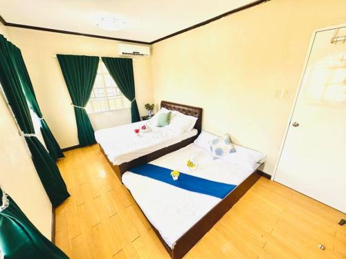 a small room with two beds in a room at Hidden Gem: Cebu's Best Escape in Talisay