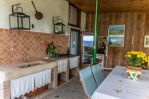 a kitchen with a sink and a table with chairs at Casa vacanze Guardea in Guardea