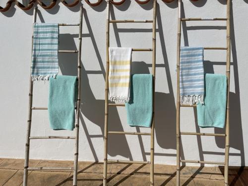 a pair of towel racks with towels on them at La Sirena del Viento in Los Caños de Meca